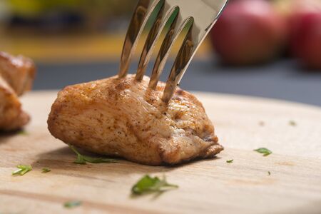 Piece of chicken meat on a fork, food conceptの写真素材