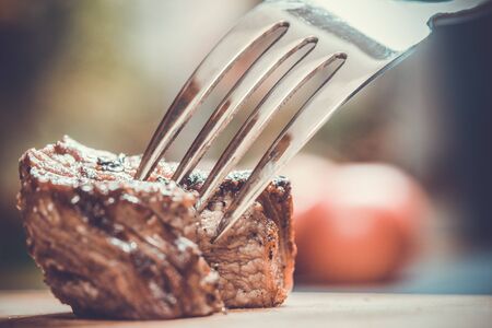 piece of meat on a fork, food conceptの写真素材