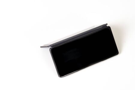 Black smartphone with two screens on a white