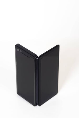Black smartphone with two screens on a whiteの写真素材