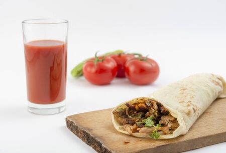 Shawarma, tomatoes and tomato juice on a whiteの写真素材