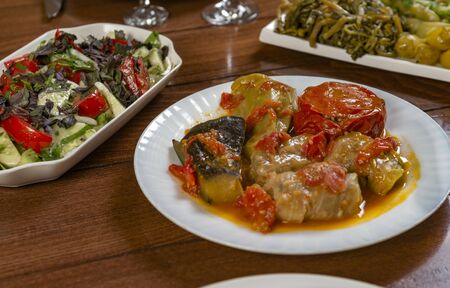 Dolma with cabbage, eggplant, tomatoes and pepper. Cabbage rolls with meat, rice and vegetables.Traditional Caucasian, Ottoman, Turkish cuisine.の写真素材