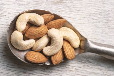 nuts in big vintage silver spoon. almond