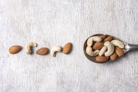 nuts in big vintage silver spoon. almondの写真素材