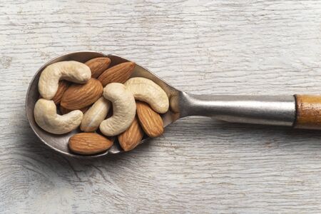 nuts in big vintage silver spoon. almondの写真素材