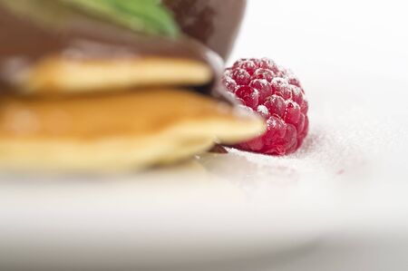 stack of pancakes with chocolate sauce.pancake with chocolate and raspberries in white background