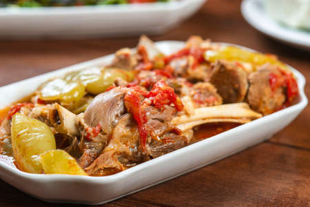 stewed lamb on the bone with vegetables on wooden deskの写真素材