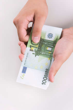 Man counting money, economy concept, allocation of money.Crisis after the covid-19 epidemic .Euro falling or rising.の写真素材