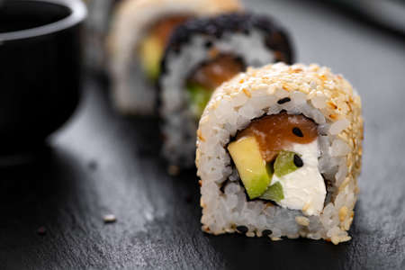 Sushi roll with rice, cucumber, avocado, salmon, sesame. Sushi menu. Japanese food.の写真素材
