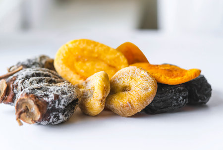 dried fruits lie on a white background, all kinds, rice, dried apricots, peach and grusha.Copy space