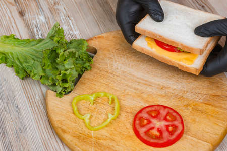 Close up of man preparing sandwiches on deskの写真素材