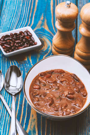 Healthy bean soup with red beans, Homemade Soup on blue wooden background, Vegetarian Food.の写真素材