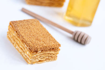 piece of homemade honey cake on white background.