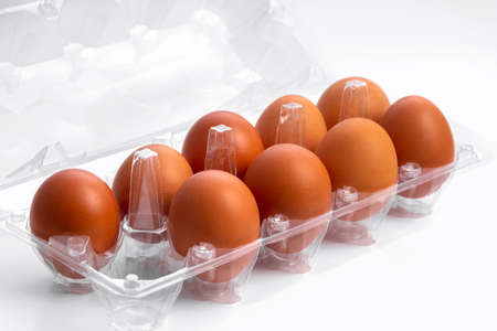 Open box with six whole brown eggs on white background