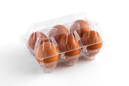 Brown chicken eggs in a plastic package on white background. 6 pieces brown eggs.