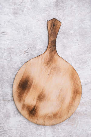 cutting board on a white wooden table.view from aboveの写真素材