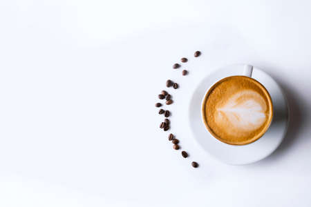 Latte coffee in white coffee cup with plate on white background. cappuccino coffee