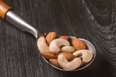 nuts in big vintage silver spoon. almondの写真素材
