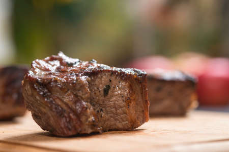 piece of meat on a fork on wodden deskの写真素材