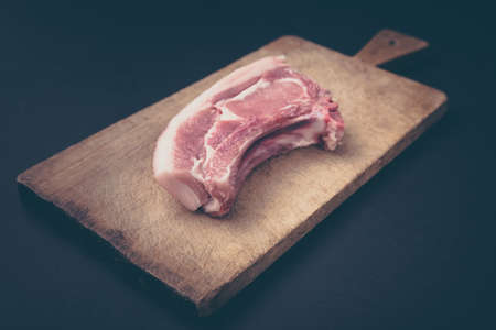 Raw steak with over rustic wooden board.の写真素材