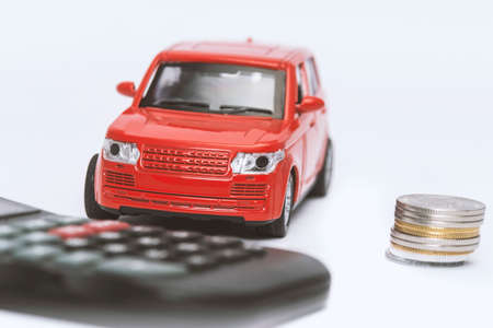 red car and calculator on white background. insurance concept