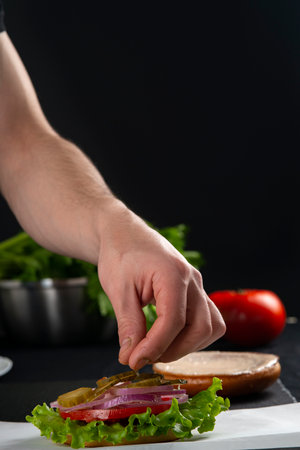 Detail view of chef serving burgersの写真素材