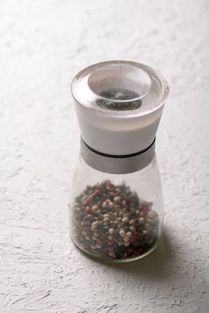 glass pepper mill on white background