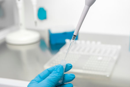 Doctor holding blood tube test in the research laboratory.Corona virus pandemic concept.Coronavirus vaccine developmentの写真素材