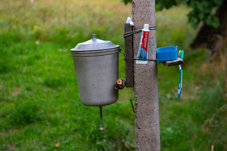 old iron rustic washbasin on a green backgroundの写真素材