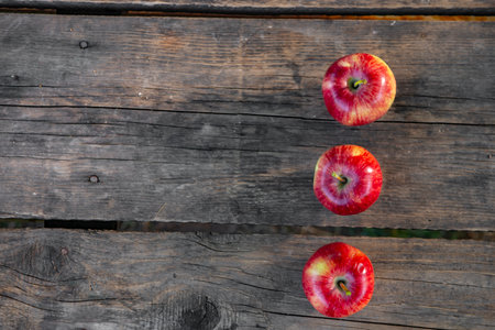 Ripe red apples on wooden background.の写真素材