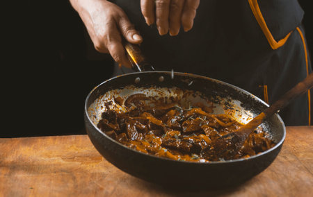 The cook prepares meat with vegetables and onions in a bowl. oriental cuisineの写真素材
