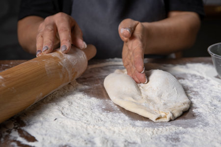 chef making dough with flour and herbsの写真素材
