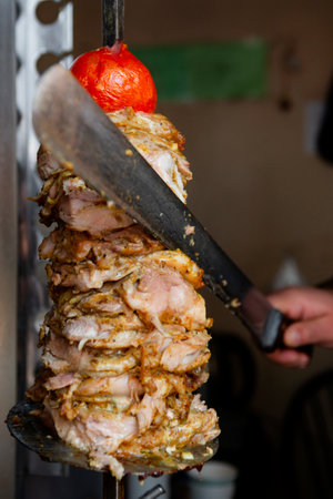Man cutting prepared meat for Shawarmaの写真素材