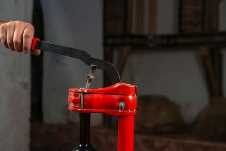 close-up of a man corking a bottle of wine at a wineryの写真素材