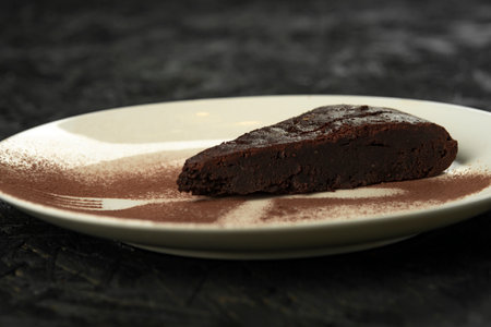 Chocolate brownie with ice cream and berries on a black backgroundの写真素材