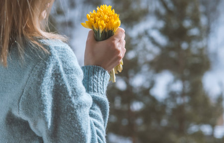 woman holding bouquet of yellow flowersの写真素材