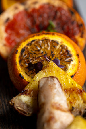 Slices of dried orange and grapefruit on a wooden boardの写真素材