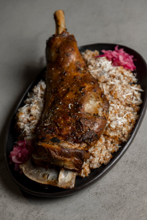 Leg of lamb with rice and red onion on gray backgroundの写真素材