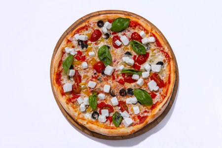 freshly baked pizza with feta cheese slicers on white backgroundの写真素材