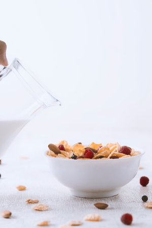 Healthy breakfast. Cornflakes, milk and berries on white backgroundの写真素材
