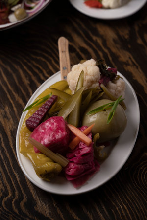 Pickled vegetables in a plate on a wooden table.の写真素材