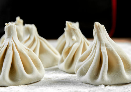 Chef cook making khinkali on wooden table. Process preparation Georgian meal. food conceptの写真素材