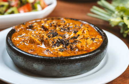 Thai spicy chili sauce with pork in black bowl on wooden tableの写真素材