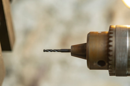 Milling machine cutting metal and wood with milling head, close-up.