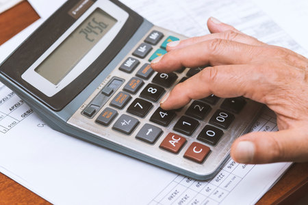Close up of hand with calculator on the table. Business concept.