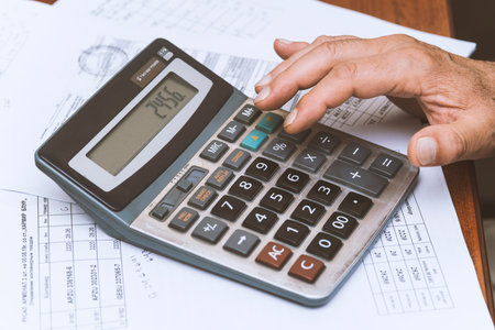 Close up of hand with calculator on the table. Business concept.