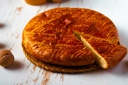 Homemade baked pie served on a shabby table with a cup of tea with autumn leaves and walnuts, autumn compositionの写真素材