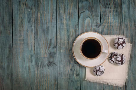 Cup of coffee with cookies on a wooden table, top view, background, copy space, breakfastの写真素材