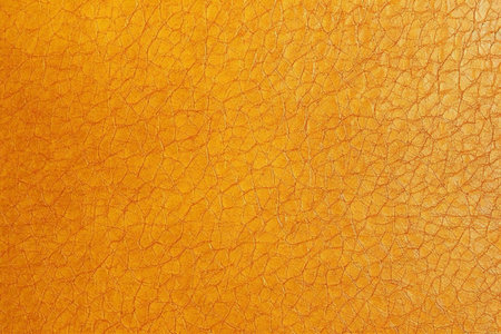Orange leather texture background. Close up of orange leather texture background.の素材