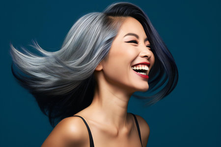 Portrait of a beautiful asian woman with blue hair and smileの素材